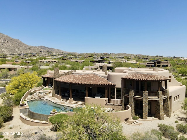 11105 E Tamarisk Way, Scottsdale, AZ 85262 - rear view of property featuring a tile roof, an outdoor pool, a chimney, a mountain view, and stucco siding