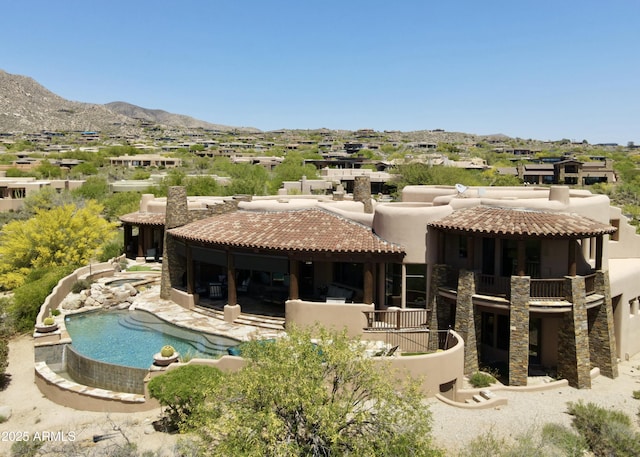 11105 E Tamarisk Way, Scottsdale, AZ 85262 - back of house featuring stucco siding, a tile roof, a mountain view, a balcony, and an outdoor pool