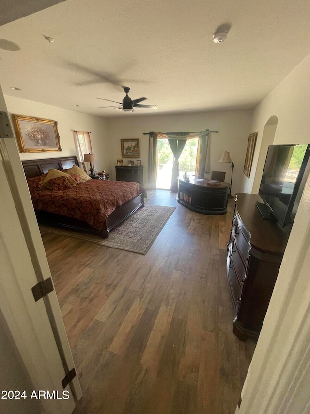 bedroom with ceiling fan and wood-type flooring