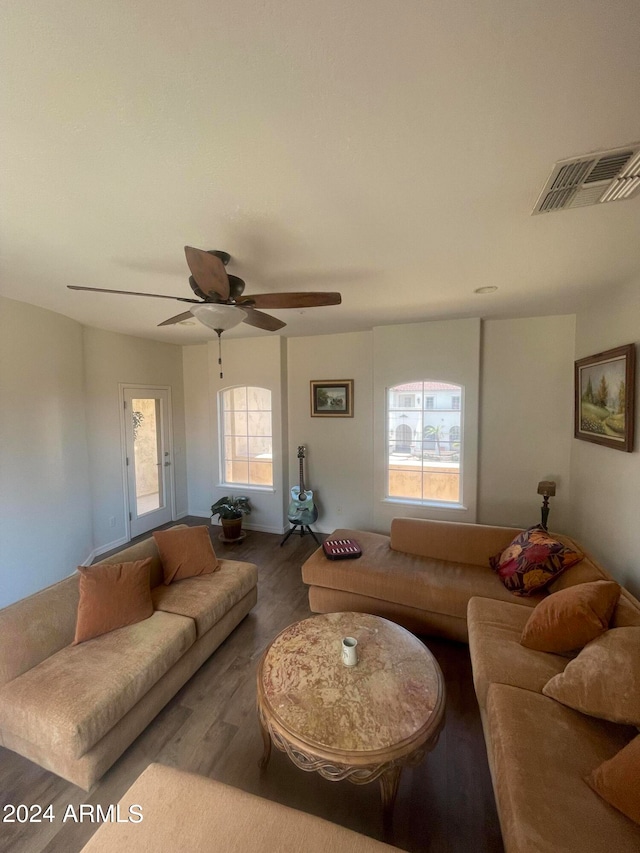 living room with wood-type flooring and ceiling fan