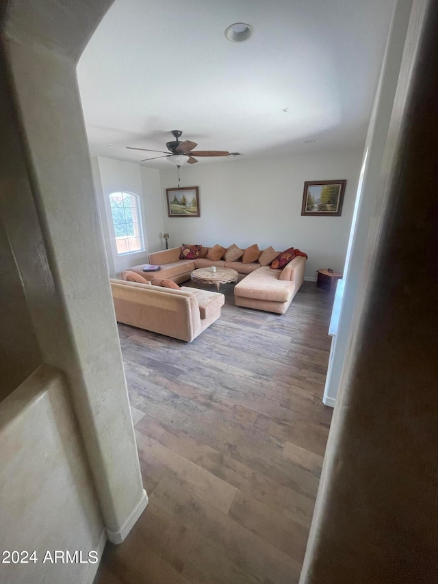 living room with wood-type flooring and ceiling fan