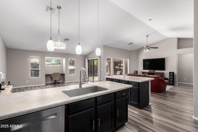 kitchen featuring a sink, visible vents, open floor plan, dishwasher, and vaulted ceiling
