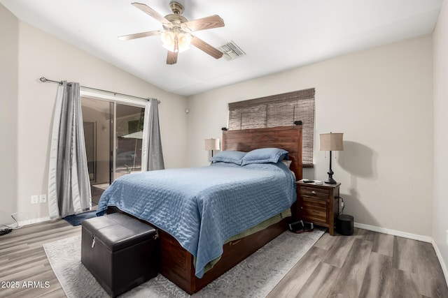 bedroom with visible vents, access to exterior, baseboards, vaulted ceiling, and wood finished floors