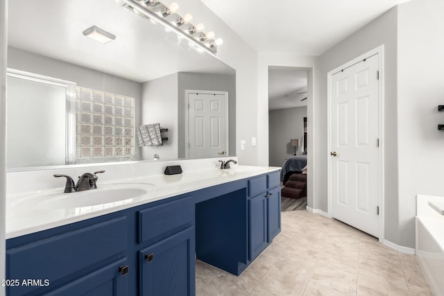 full bath with tile patterned flooring, a bathing tub, double vanity, and a sink