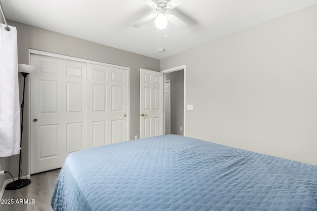 bedroom with a closet, ceiling fan, and wood finished floors