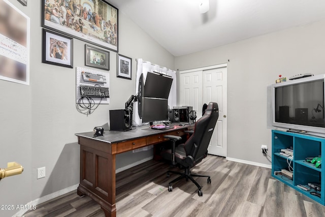 office space with baseboards, wood finished floors, and lofted ceiling