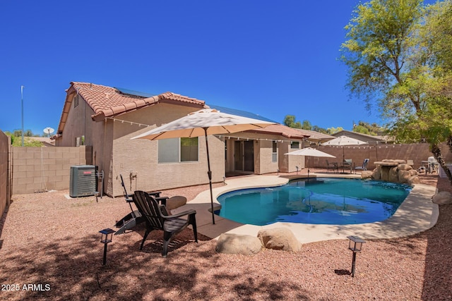 view of swimming pool featuring central air condition unit, a fenced in pool, a fenced backyard, and a patio area