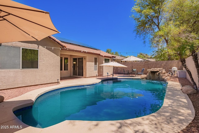 view of swimming pool featuring a patio, outdoor dining space, a fenced in pool, and a fenced backyard