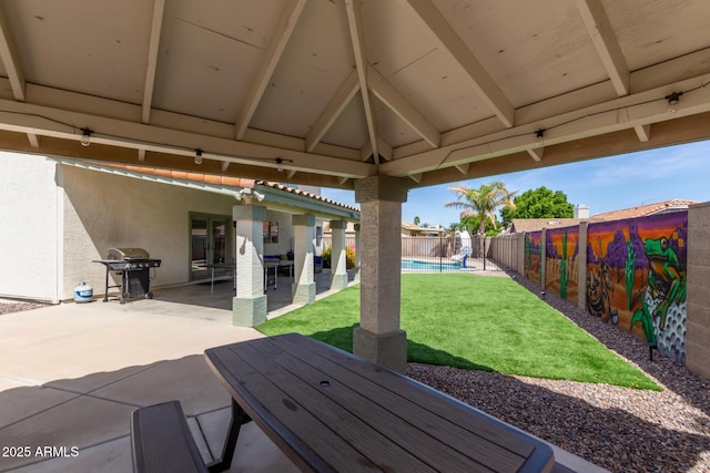 view of patio / terrace featuring grilling area, a fenced in pool, and a fenced backyard