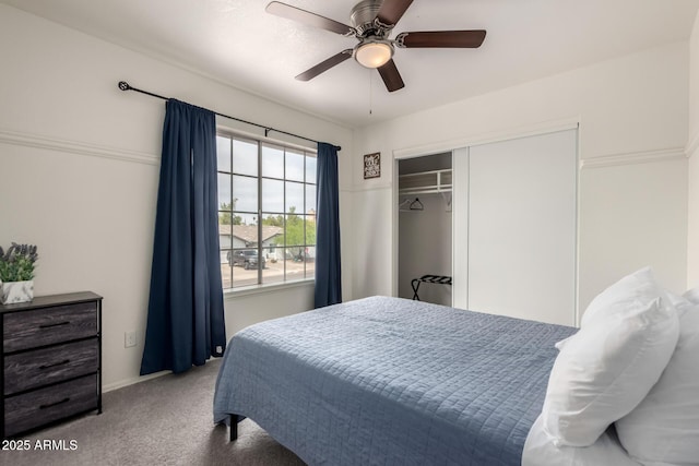 carpeted bedroom with a ceiling fan and a closet