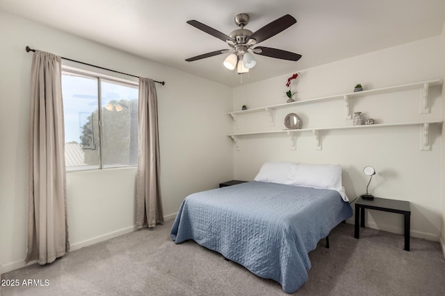 carpeted bedroom with baseboards and ceiling fan