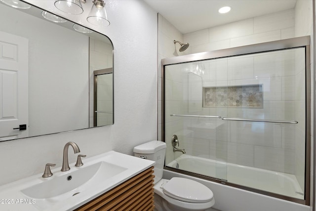 full bath with toilet, combined bath / shower with glass door, vanity, and recessed lighting