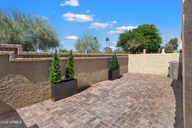 view of patio / terrace featuring cooling unit and a fenced backyard