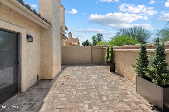 view of patio featuring fence