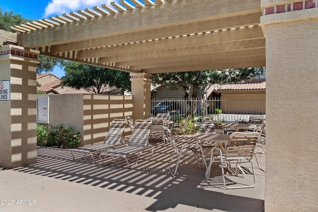 view of patio with fence, a pergola, and outdoor dining space