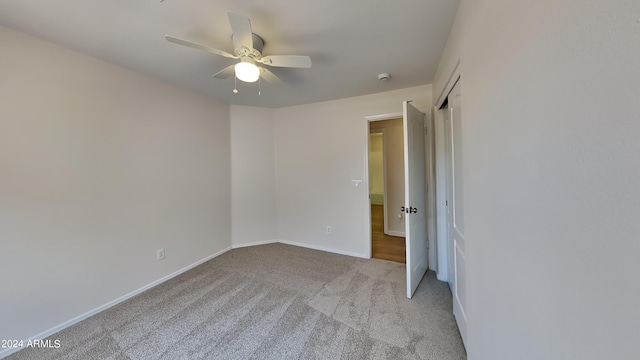 carpeted empty room with ceiling fan