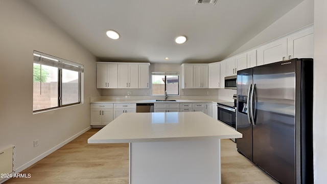 kitchen featuring white cabinetry, sink, a kitchen island, and appliances with stainless steel finishes