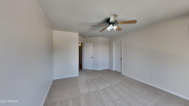 spare room with light carpet and ceiling fan