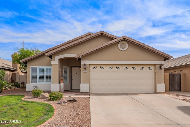 ranch-style house with an attached garage, stucco siding, a tiled roof, and concrete driveway