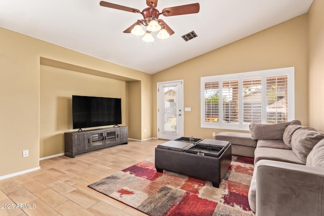 living area featuring ceiling fan, visible vents, baseboards, lofted ceiling, and light wood-style floors