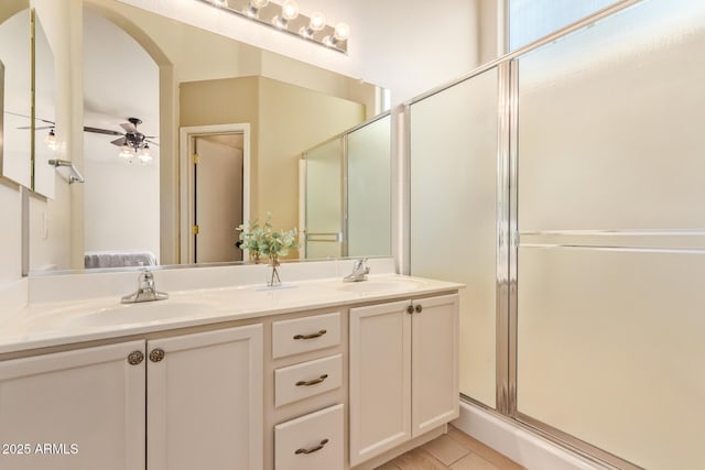 bathroom with ensuite bathroom, a sink, a ceiling fan, and double vanity