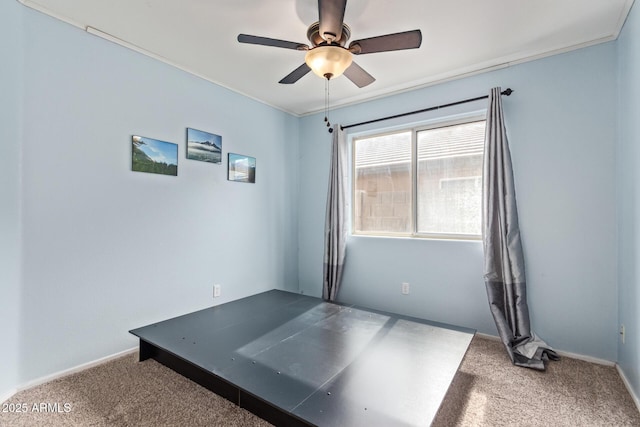 interior space featuring a ceiling fan and baseboards