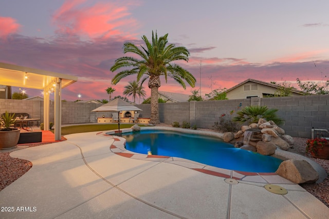 pool at dusk with a fenced backyard, a fenced in pool, and a patio area