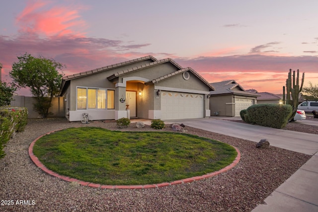 ranch-style home with a garage, stucco siding, concrete driveway, and a front yard