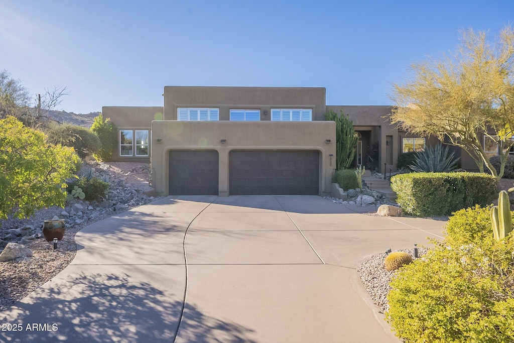 southwest-style home with a garage