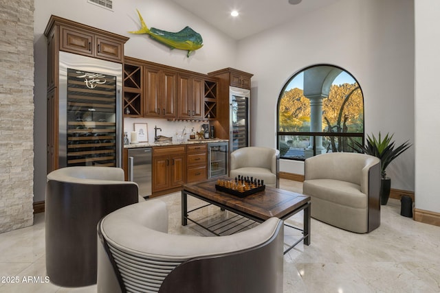 bar featuring a towering ceiling and wine cooler