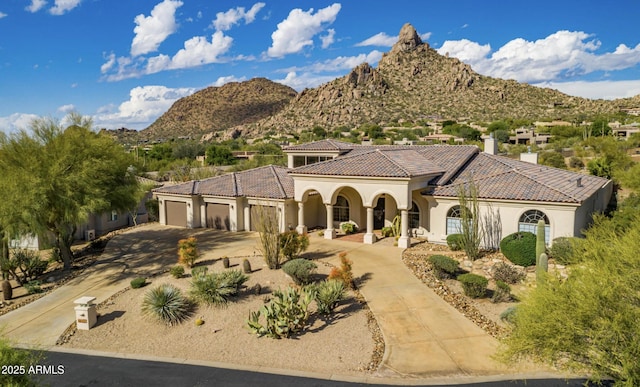 view of front facade featuring a mountain view and a garage