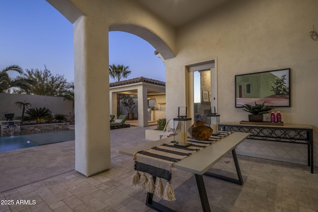 view of patio terrace at dusk