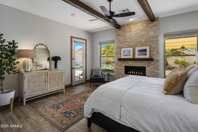 bedroom with dark hardwood / wood-style flooring, a fireplace, access to outside, ceiling fan, and beam ceiling