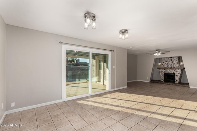 unfurnished living room featuring light tile patterned flooring and ceiling fan