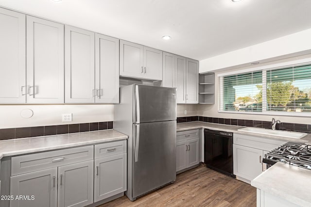 kitchen with dark hardwood / wood-style flooring, sink, gray cabinets, and appliances with stainless steel finishes