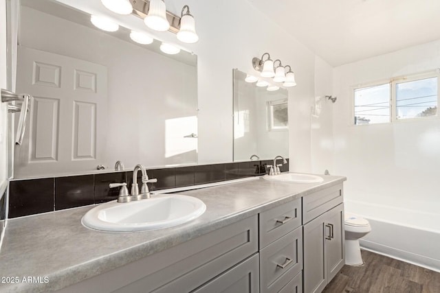 bathroom with vanity, hardwood / wood-style flooring, and toilet