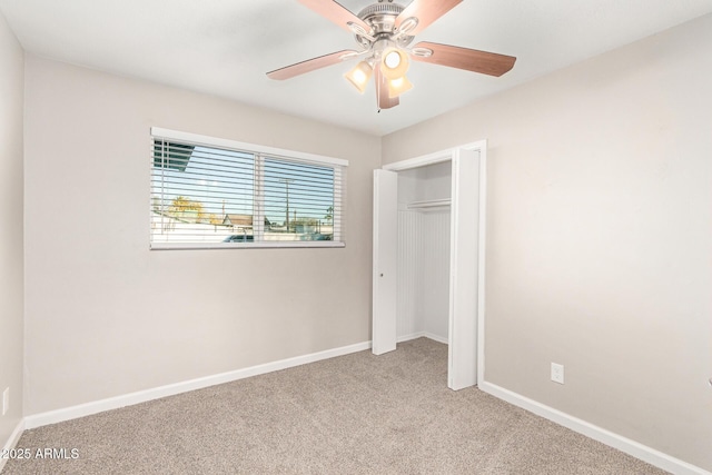 unfurnished bedroom featuring a closet, ceiling fan, and carpet flooring