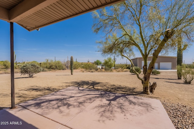 931 E Whiteley St, Apache Junction, AZ 85119 - view of yard featuring a garage, an outbuilding, and a patio