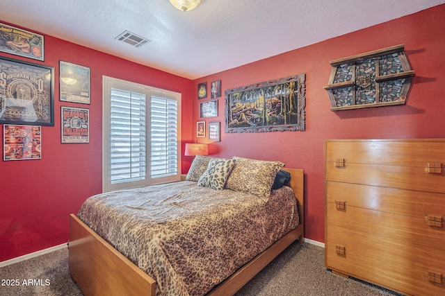 carpeted bedroom featuring a textured ceiling