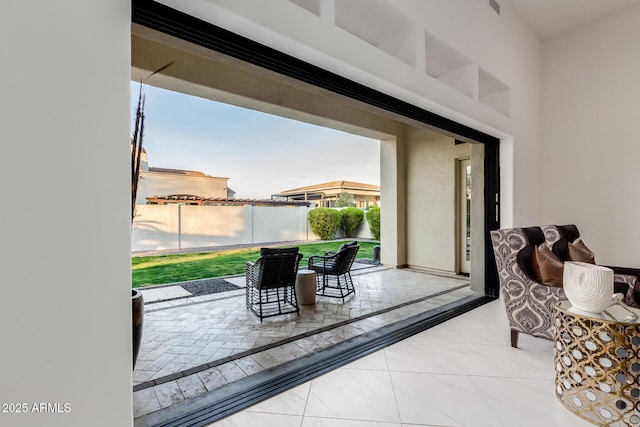 interior space with marble finish floor and a water view