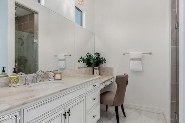 bathroom with baseboards, marble finish floor, a stall shower, and vanity