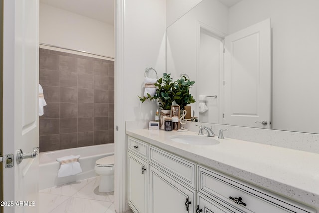 full bathroom with tiled shower / bath, vanity, and toilet