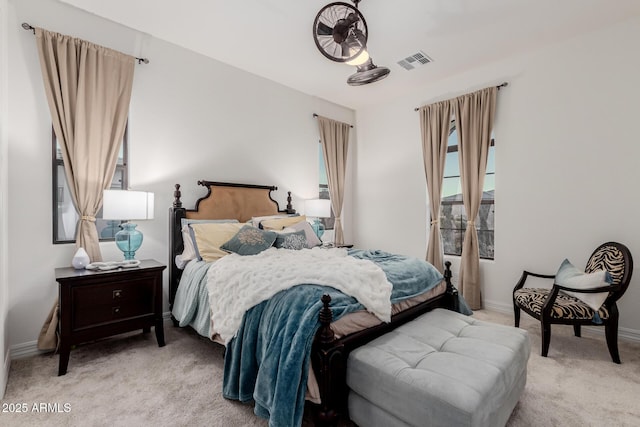 bedroom featuring light carpet, visible vents, and baseboards