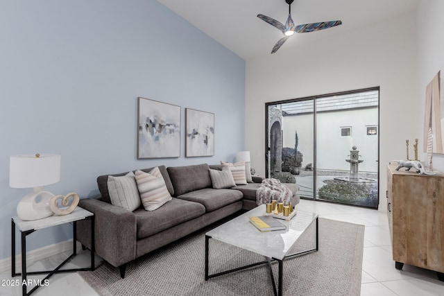 tiled living room featuring ceiling fan and high vaulted ceiling