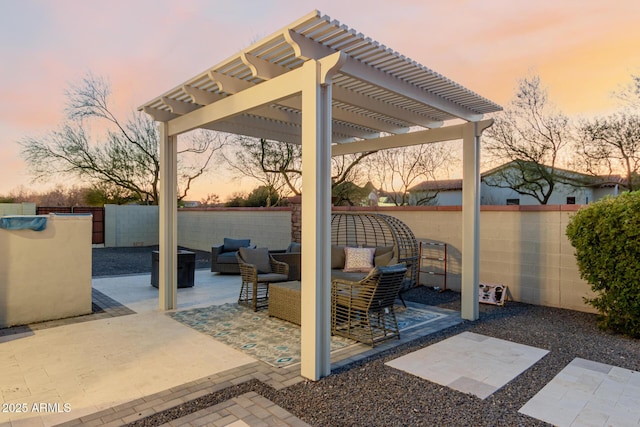 patio terrace at dusk with a pergola and outdoor lounge area