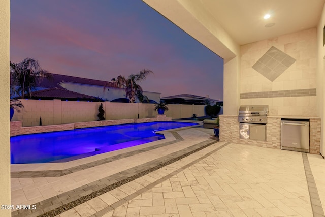 pool at dusk featuring a patio, a fenced backyard, grilling area, a fenced in pool, and an outdoor kitchen