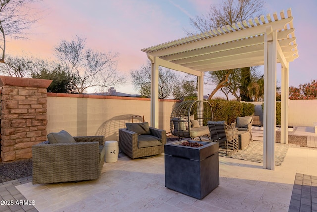 patio terrace at dusk with a pergola and an outdoor living space with a fire pit