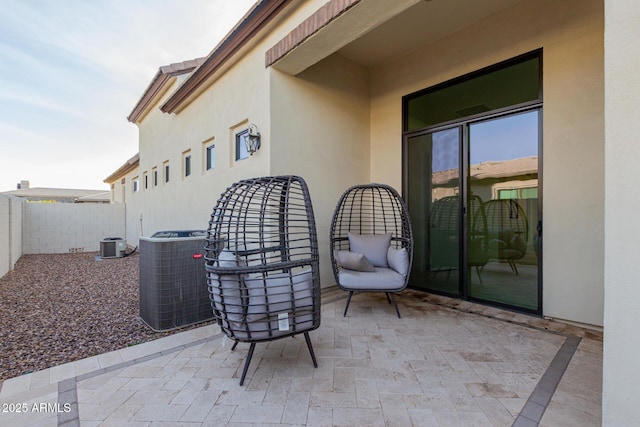 view of patio / terrace featuring cooling unit and fence