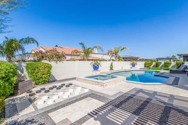 view of swimming pool with a pool with connected hot tub, a fenced backyard, and a patio area