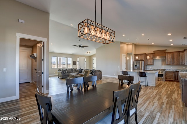 dining space featuring light wood finished floors, recessed lighting, and baseboards